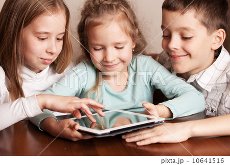 Children playing on tablet Children playing on tablet 10641516