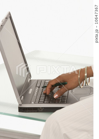 Woman's hand typing on laptop 10647367