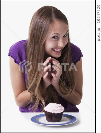 Excited teenage girl about to eat a cupcake 10647529