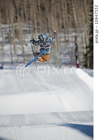 A downhill skier jumping 10647552