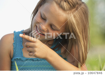 Young girl looking at a ladybug Young girl looking at a ladybug 10647846