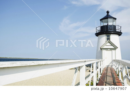 Lighthouse on sandy beach 10647907