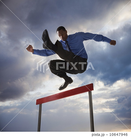 Businessman jumping over a hurdle Businessman jumping over a hurdle 10647946