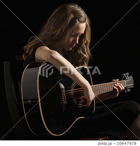 Young woman playing guitar 10647978