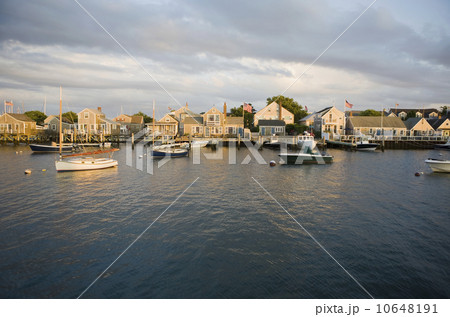 Boats in harbor with village in background 10648191