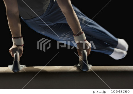Gymnast swinging on pommel horse Gymnast swinging on pommel horse 10648260