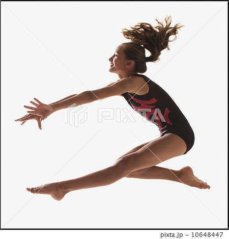 Female gymnast (12-13) leaping 10648447