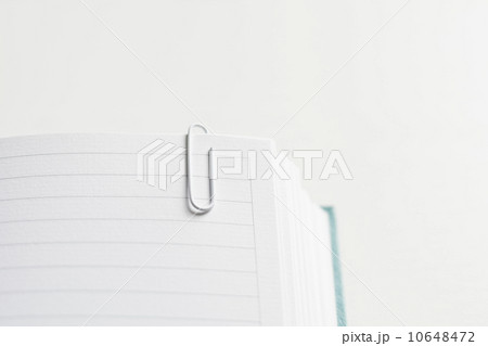 Open and empty journal with paper clip attached 10648472