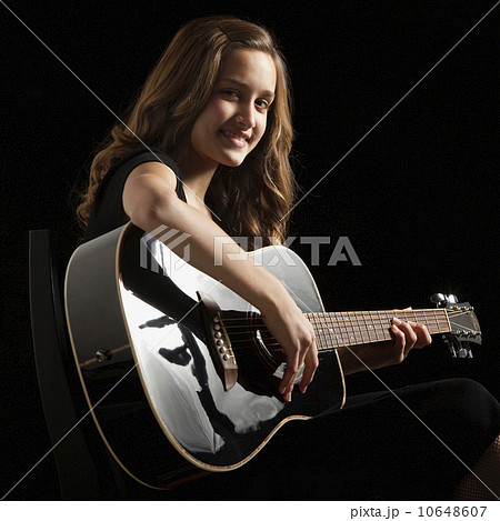 Young woman playing guitar 10648607
