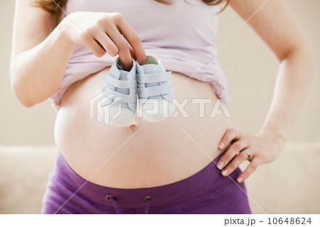 USA, Utah, Lehi, Young pregnant woman holding baby boots 10648624