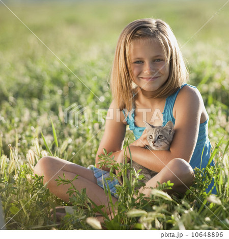 Young girl holding a kitten 10648896
