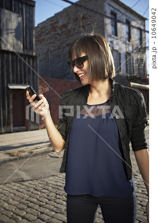 USA, New York City, Brooklyn, woman in street using phone USA, New York City, Brooklyn, woman in street using phone 10649042