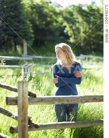 Young woman behind fence Young woman behind fence 10649075