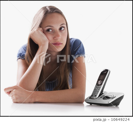 Bored woman waiting for the phone to ring Bored woman waiting for the phone to ring 10649224