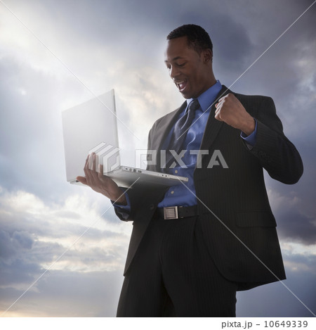 Successful businessman holding a laptop computer 10649339