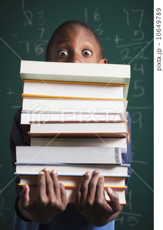 Boy holding stack of books Boy holding stack of books 10649789