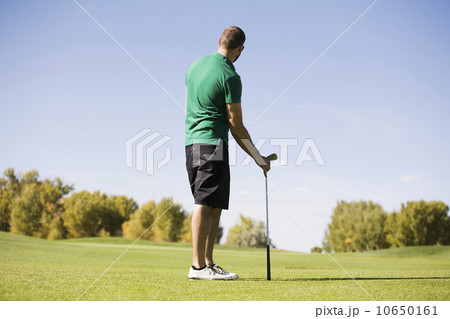 Rear view of man standing on golf course Rear view of man standing on golf course 10650161
