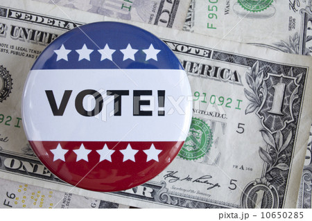 Studio shot of vote pin and one dollar banknotes 10650285