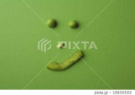 Anthropomorphic face made up from green peas  10650503