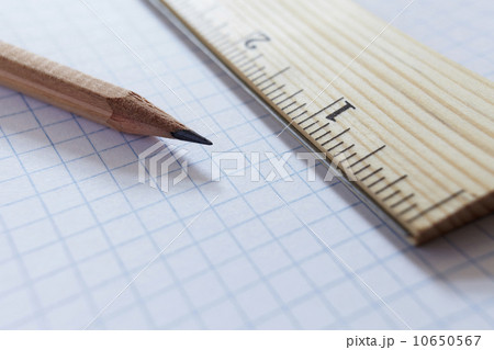 Ruler and pencil on graph paper, studio shot Ruler and pencil on graph paper, studio shot 10650567