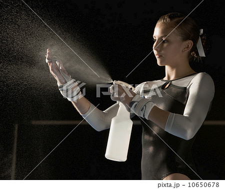 Gymnast spraying water on hands 10650678