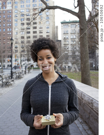 Portrait of woman holding small gift box Portrait of woman holding small gift box 10650692