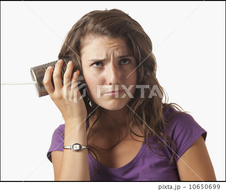 Young woman holding tin can phone Young woman holding tin can phone 10650699