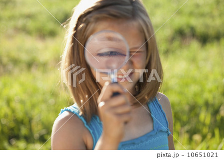 Young girl holding a magnifying glass Young girl holding a magnifying glass 10651021