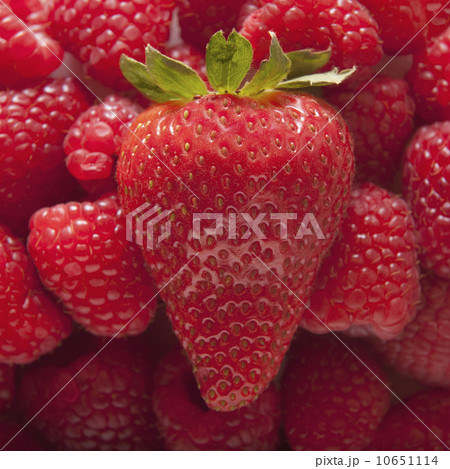 Strawberry on top of pile of raspberries Strawberry on top of pile of raspberries 10651114