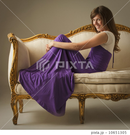Elegant woman sitting on antique sofa Elegant woman sitting on antique sofa 10651305