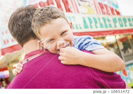 Father and son (4-5) in amusement park 10651472