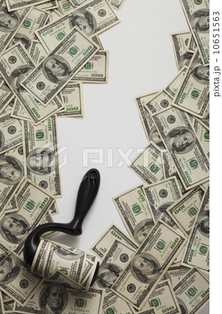 Lint roller picking up money 10651563