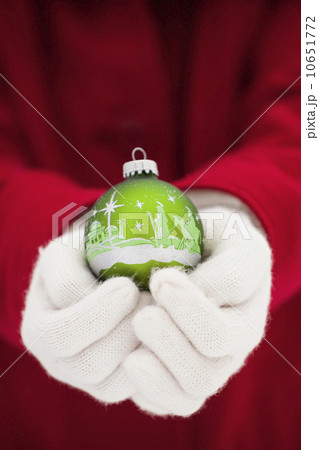 Young woman holding Christmas bauble 10651772