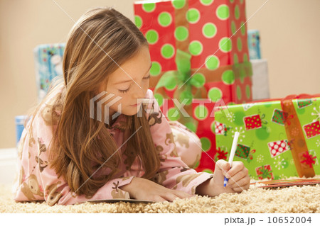 Girl (6-7) preparing Christmas presents 10652004