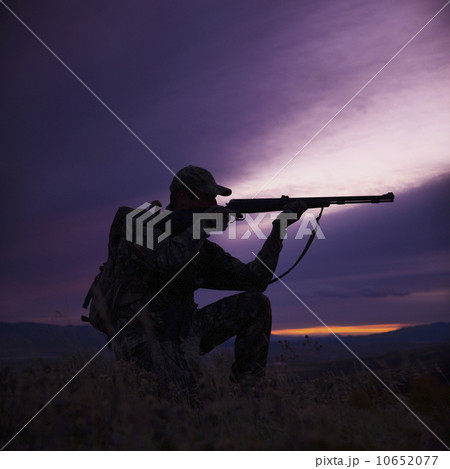 Hunter pointing his rifle Hunter pointing his rifle 10652077