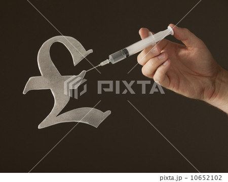 Hand holding syringe on "Pound" sign 10652102