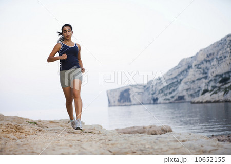France, Marseille, Woman jogging by seaside 10652155