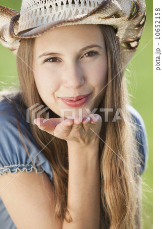 Beautiful cowgirl blowing a kiss Beautiful cowgirl blowing a kiss 10652158