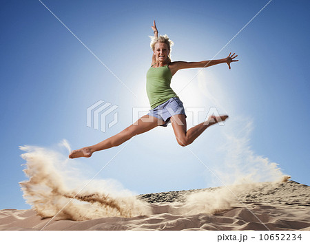Female dancer jumping in sand Female dancer jumping in sand 10652234