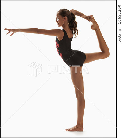 Female gymnast (12-13) balancing on one leg Female gymnast (12-13) balancing on one leg 10652260
