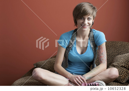 Portrait of young woman sitting on sofa Portrait of young woman sitting on sofa 10652328
