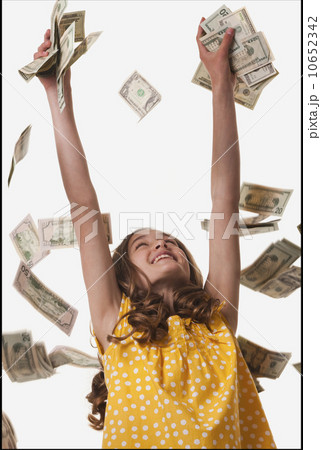 Young girl throwing money in the air 10652342