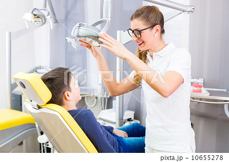 Dentist giving patient advice in dental surgery 10655278