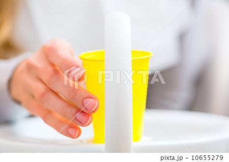 Patient rinse mouth with a cup of water at dentist 10655279