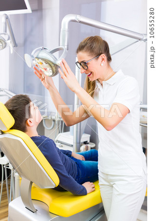 Dentist giving patient advice in dental surgery 10655280