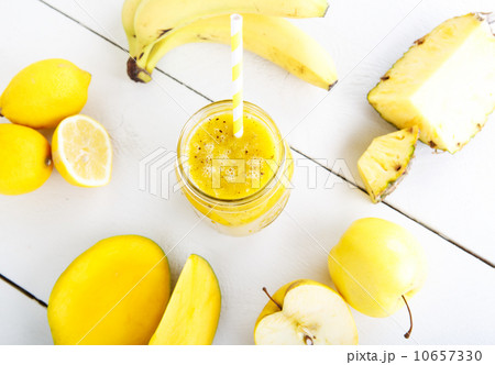 Fresh organic yellow smoothie with banana, apple, mango, pear, p Fresh organic yellow smoothie with banana, apple, mango, pear, p 10657330