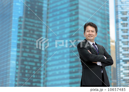 Victorious successful entrepreneur business man standing in front of glass office building 10657485