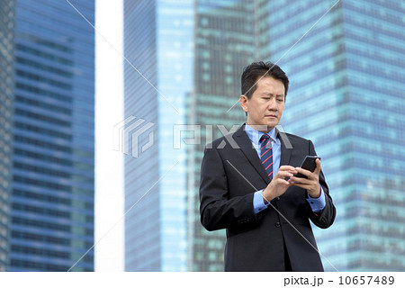 Successful entrepreneur business man using mobile phone in front of glass office building Successful entrepreneur business man using mobile phone in front of glass office building 10657489