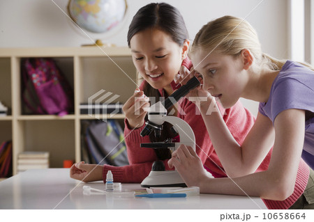 Teenage girls (14-15) working with microscope Teenage girls (14-15) working with microscope 10658664