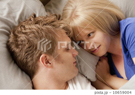 Elevated view of couple lying in bed 10659004